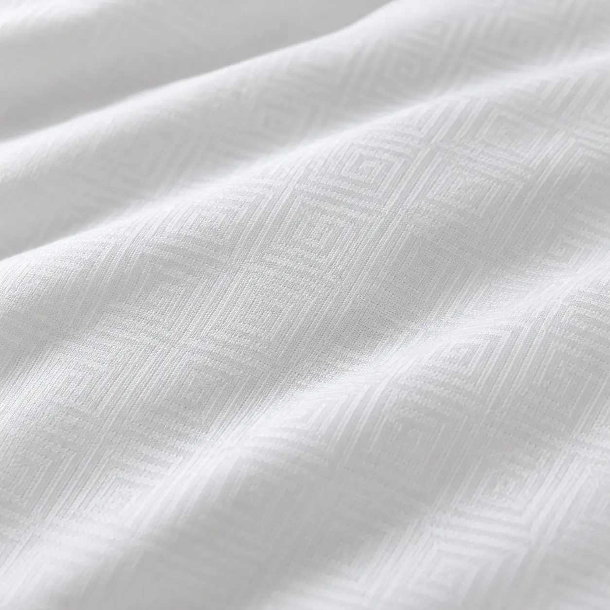 Acercamiento a la tela blanca de la almohada